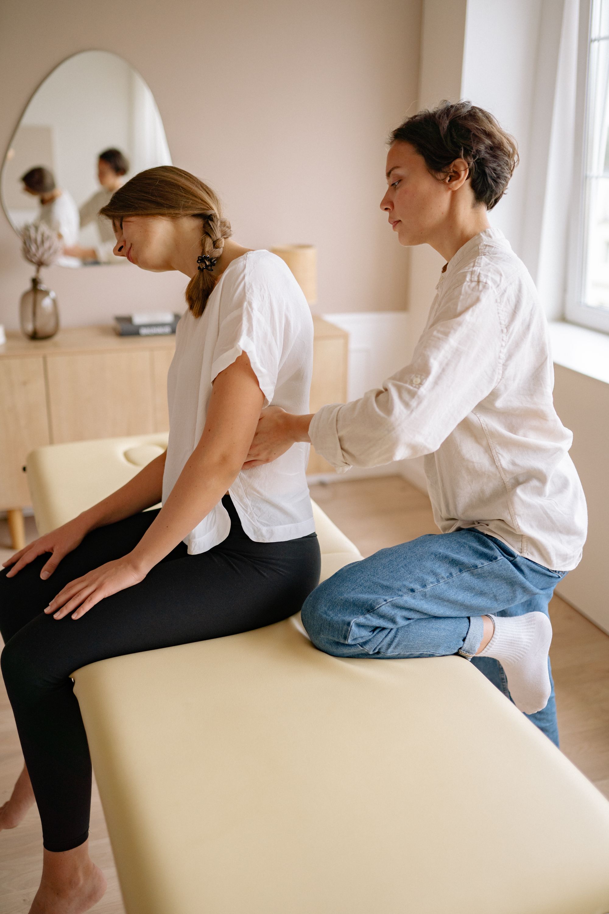Practitioner providing manual back therapy